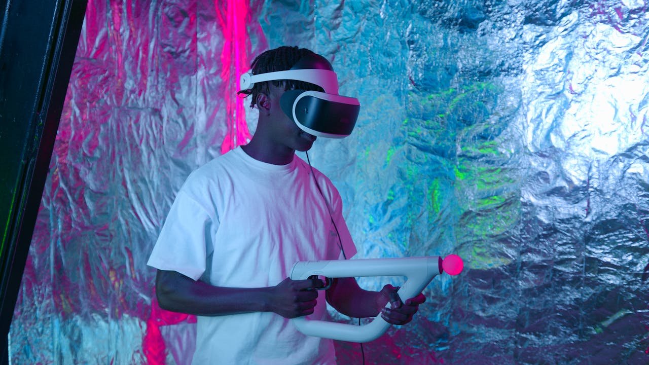 Black man using VR headset and controller in neon-lit room, focused on immersive gameplay.